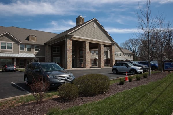 Exterior view of Forest Hills Commons with parked cars