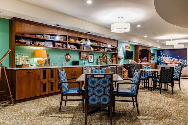 Well-decorated common area with seating and shelves
