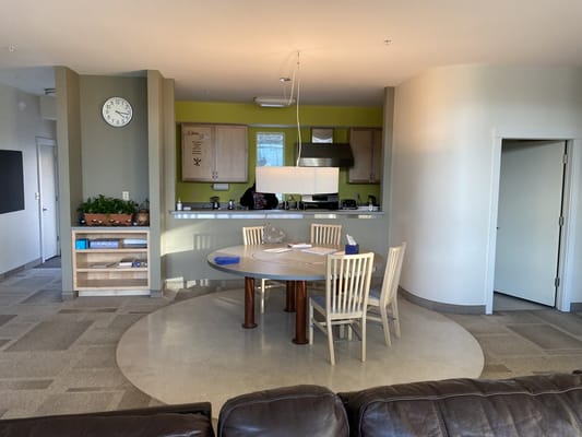 Interior common area with a dining table and kitchen