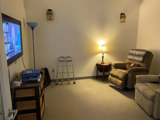 Cozy lounge area with a TV and armchairs