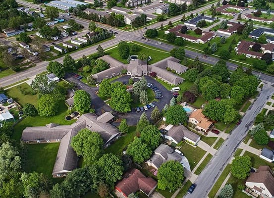 Aerial view of a senior living facility surrounded by greenery