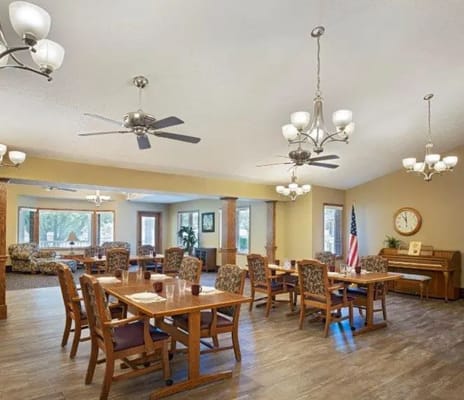 Bright dining room with tables set for residents