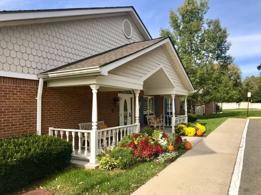 Front entrance of a senior living facility with seasonal decorations