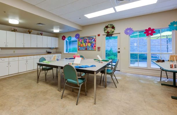 Activity room with tables, crafts, and bright decorations