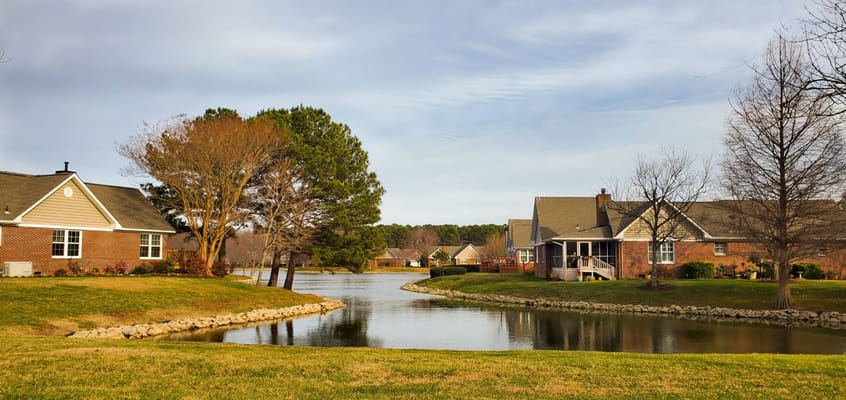 Beautiful outdoor view of senior living campus by a lake