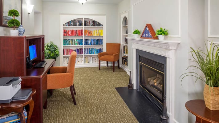 A cozy common area with bookshelves and seating