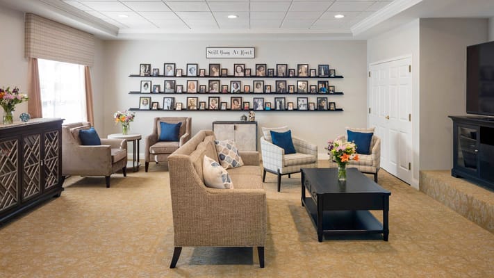 Cozy lounge area with comfortable seating and family pictures