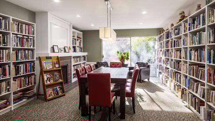 Cozy reading room with bookshelves and a table