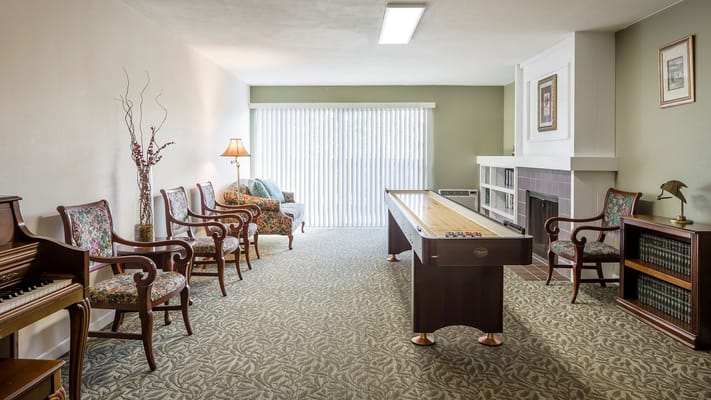 Bright common area with comfortable seating and game table