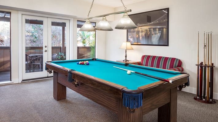 Bright common area with a pool table and seating