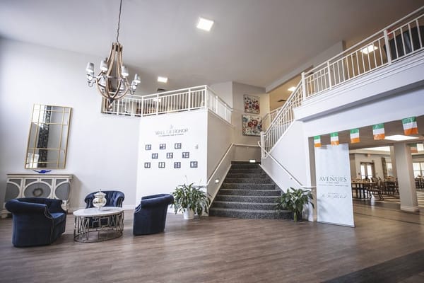 Spacious lobby with seating, chandelier, and Wall of Honor