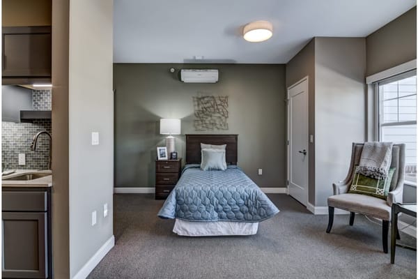 Cozy private room with bed and armchair