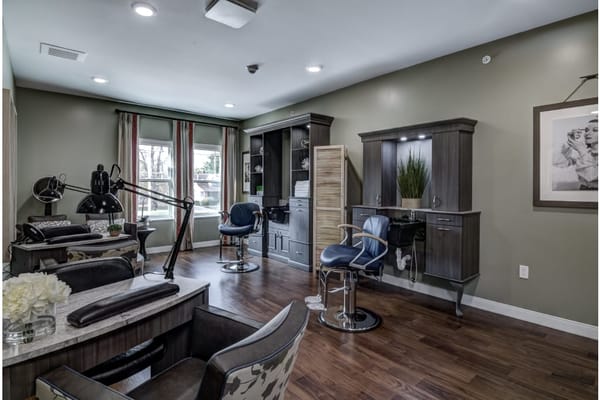 Beauty salon area with styling chairs and natural light