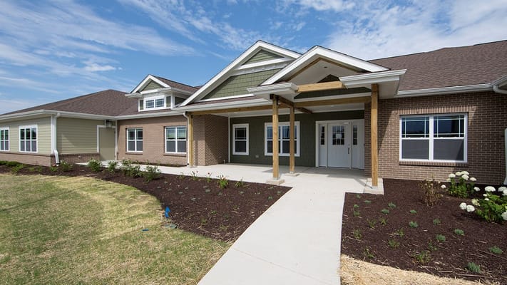 Front entrance of a senior living facility with landscaping