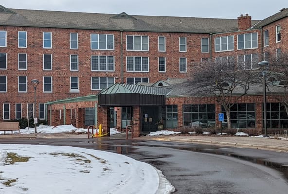 Exterior view of a senior living facility with snow