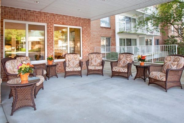 Outdoor seating area with wicker chairs and flowers