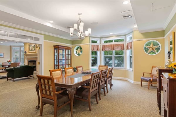 Bright dining room with a large wooden table and chairs