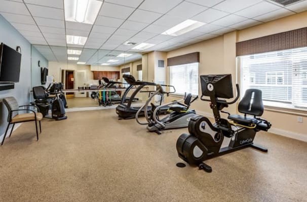 Indoor gym at Benchmark Senior Living with exercise equipment