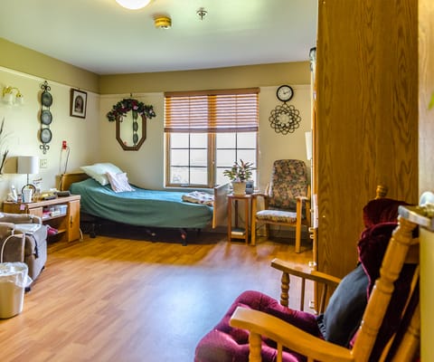 Cozy resident room with bed and chair