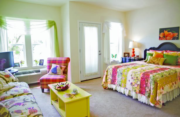 Bright and colorful bedroom with floral decor and seating area