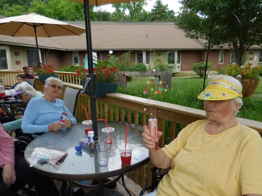 Residents enjoying a sunny day on the patio