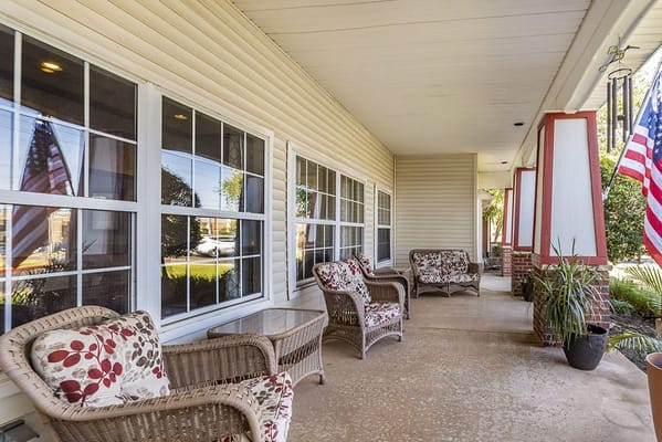 Covered patio with comfortable seating and American flags