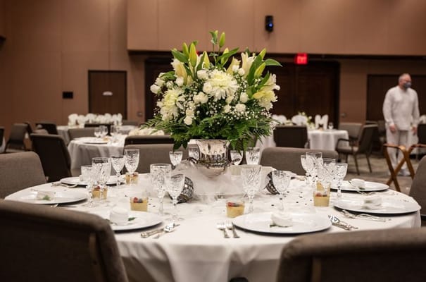 Elegantly set dining room table with floral centerpiece