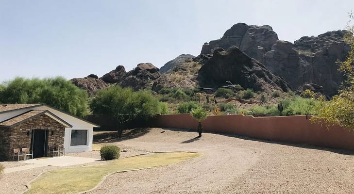 A view of a facility building with mountains in the background