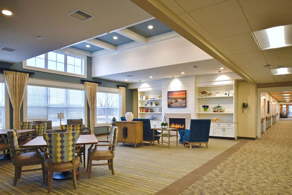 Bright lounge area with seating and fireplace