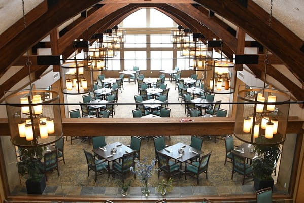 Dining area with tables and chairs under decorative lighting