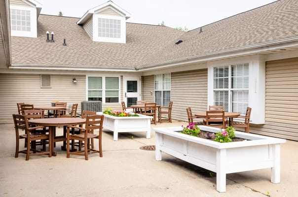 Outdoor seating area with tables and flower boxes