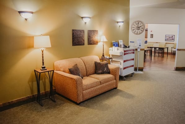 Warm living room with sofa and lamps at Copper Summit Assisted Living