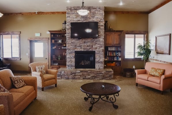 Cozy living room with stone fireplace and comfortable seating