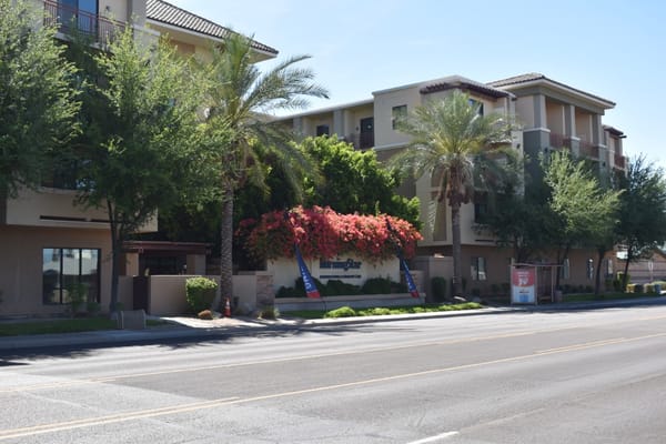 Exterior view of MorningStar Assisted Living facility with landscaping and palm trees.