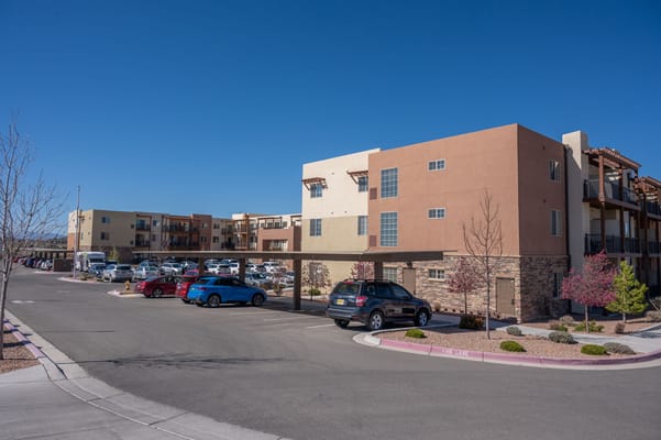 Overview of Las Soleras Senior Living facility with parked cars