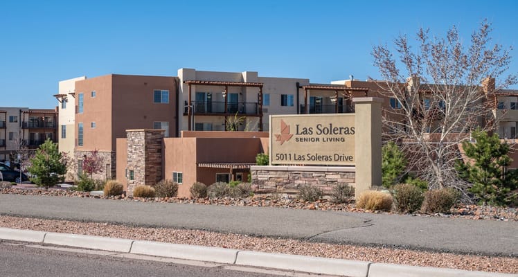 Exterior view of Las Soleras Senior Living facility with sign