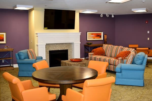 Bright common area with comfortable seating and fireplace