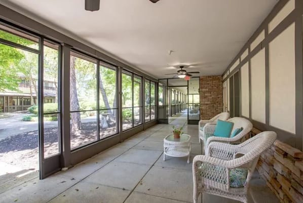 Bright sunroom with wicker chairs and views of the outdoors