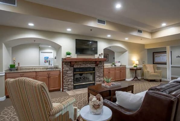 Spacious living room with comfortable seating and a fireplace.
