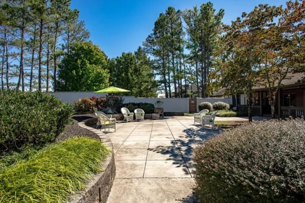 Patio area with seating and greenery
