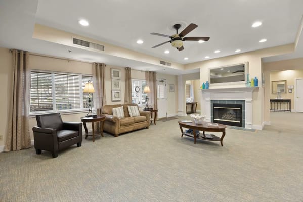 Bright common area with seating and fireplace