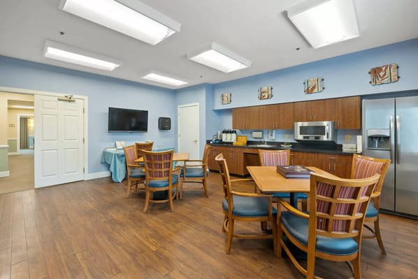 Bright common area with dining tables and kitchenette