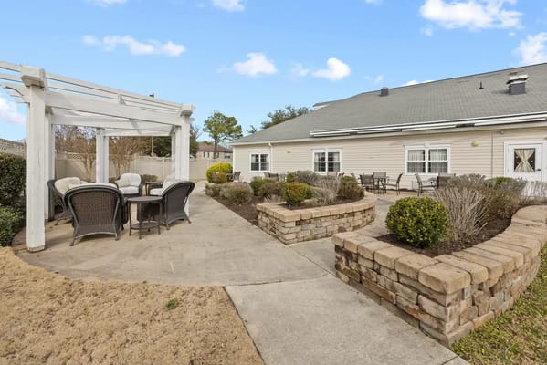 Outdoor seating area with a pergola and garden