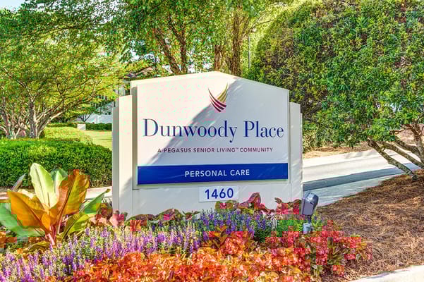 Sign for Dunwoody Place senior living community at entrance