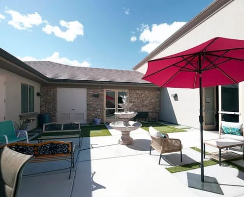 Outdoor patio area with seating and a fountain