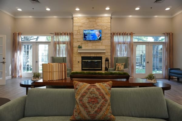 Bright and inviting common area with seating and fireplace