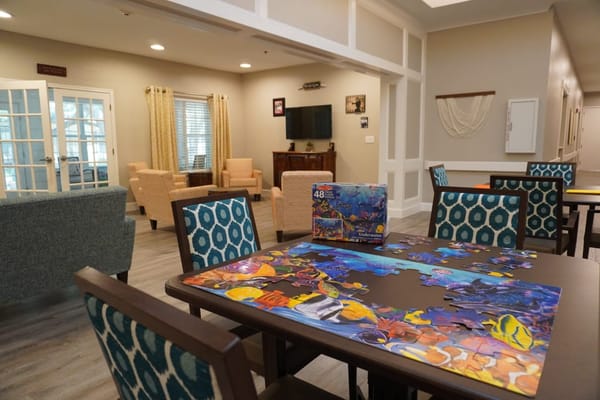 Common area with puzzle and seating for residents