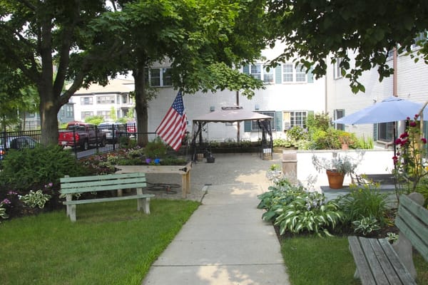 Courtyard with benches, plants, and an American flag