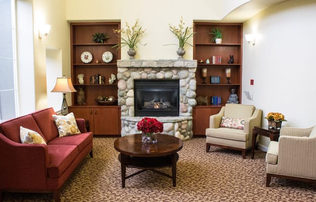 Cozy living room with a stone fireplace and seating area