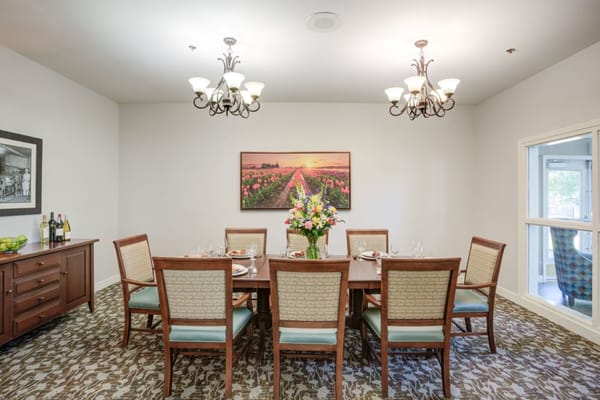 Elegant dining room setting with flowers and chairs